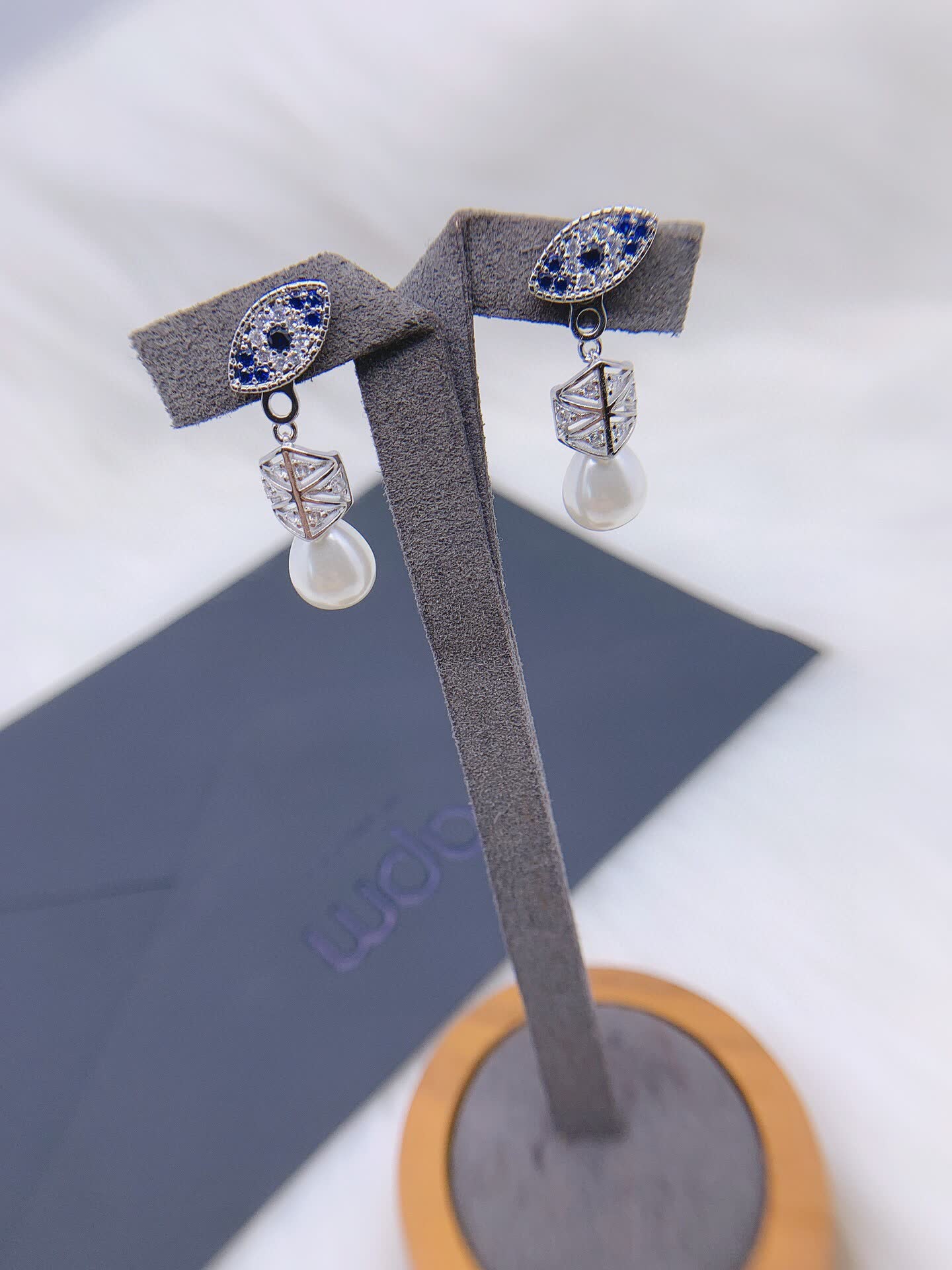 APM Monaco Elegant Pearl and Sapphire Eye Stud Earrings